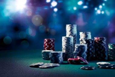 Blackjack dealer in live studio with shoe and cards visible